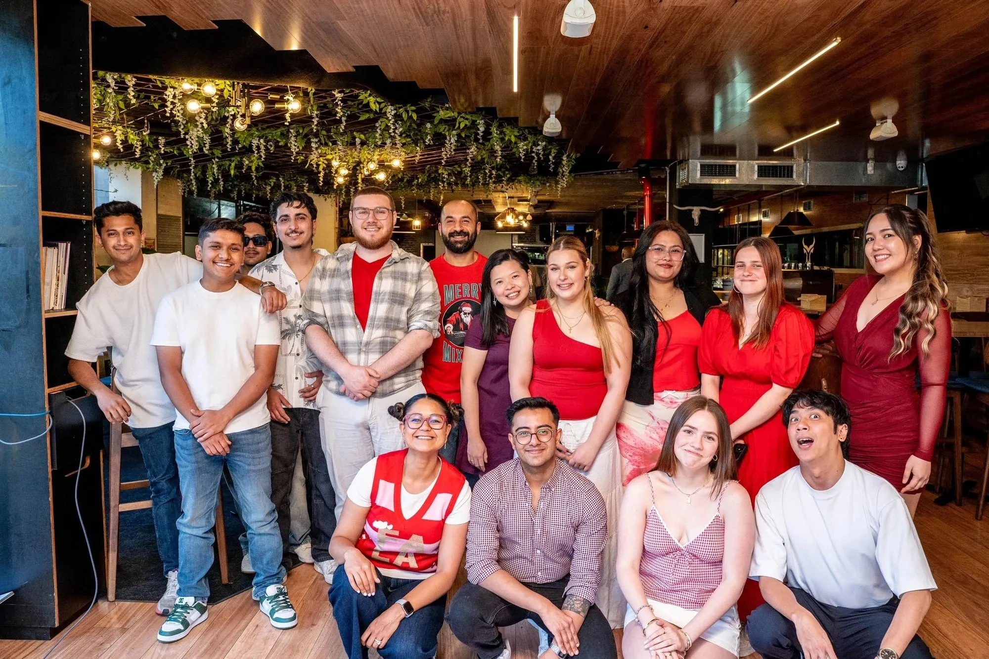 The Weston Bull team together in the dining room under the hanging vines